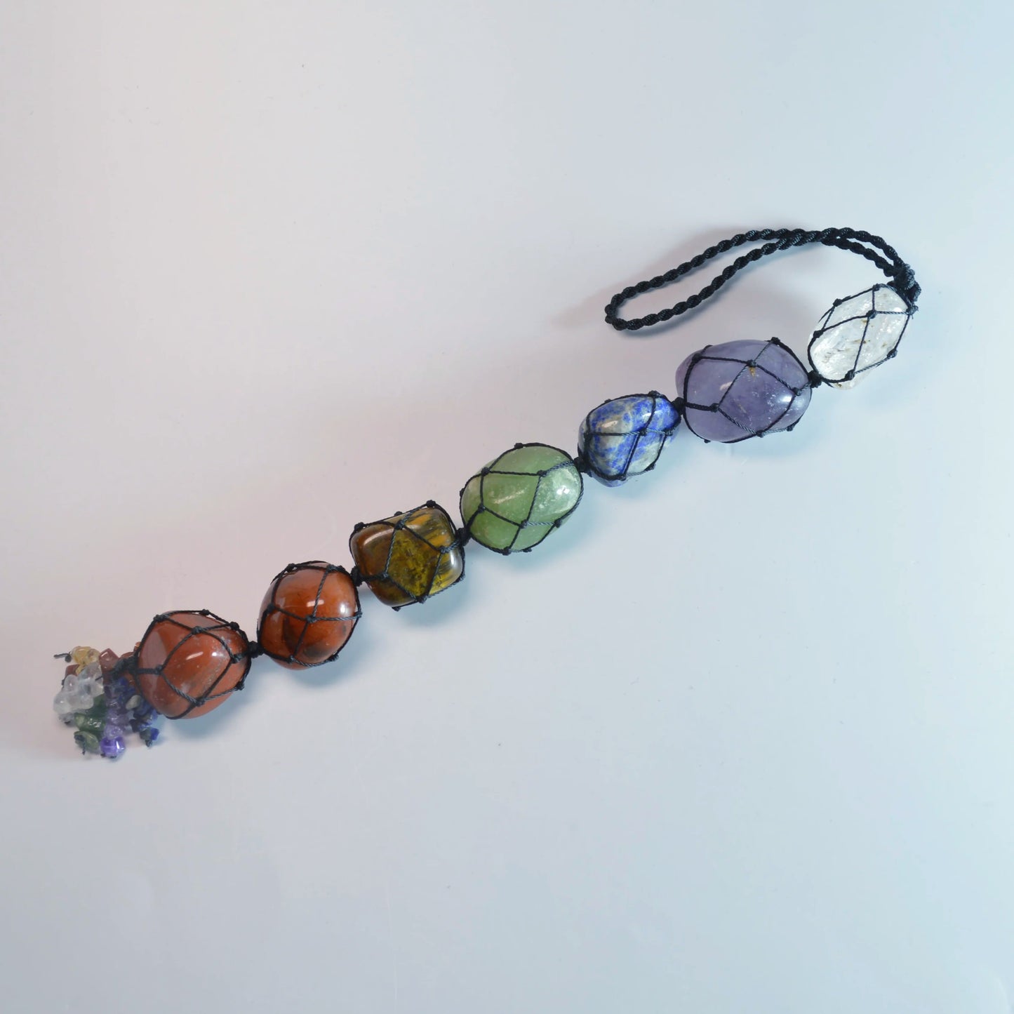 Nahaufnahme Chakra-Energieanhänger – Amethyst, Sodalith, grüner & gelber Aventurin, Karneol, Bergkristall, roter Jaspis, natürliche Farbvariationen sichtbar.