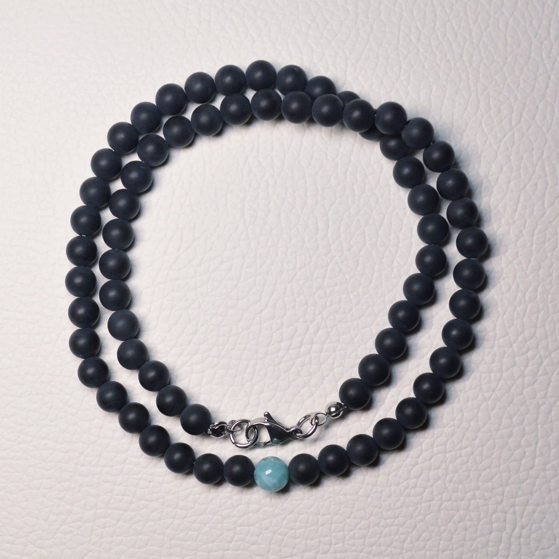 Onyx-Kette mit matten 6mm Kristallperlen und einer Larimar-Perle.